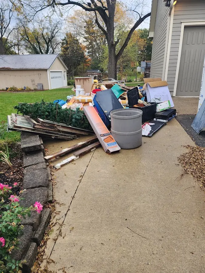 Dumpster being loaded with debris for 10 Yard Dumpster Rental in Deep River